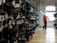 A textile expert finds the appropriate material for a custom dinner jacket at the Joseph Abboud manufacturing plant in New Bedford, MA.   [ PETER PEREIRA/THE STANDARD-TIMES/SCMG ]